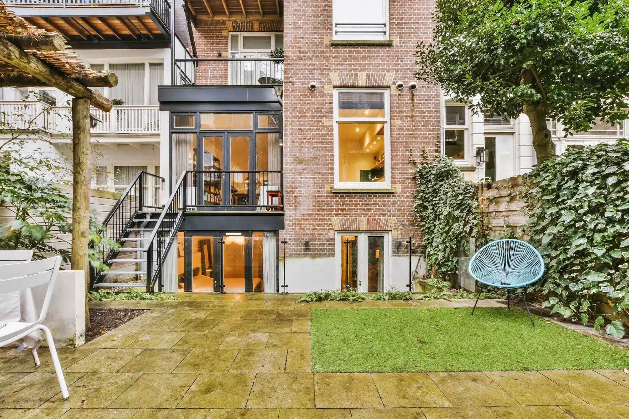 General view of the backyard with tiled floor and a dining area
